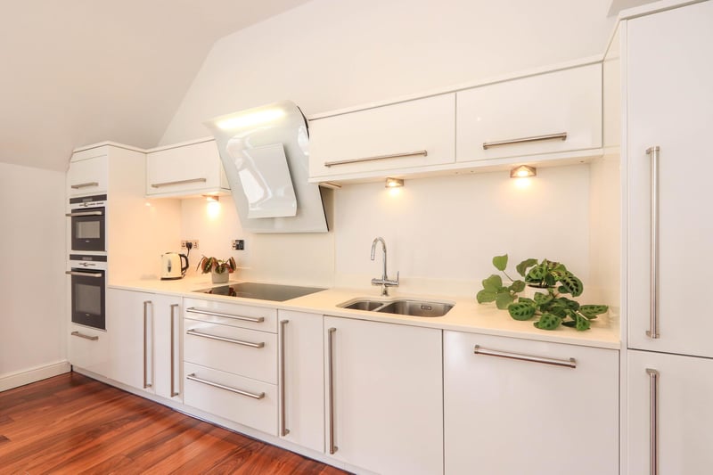 The brochure says the kitchen area is fully fitted and has a range of integrated appliances which include an induction hob with glass extractor above, oven and microwave, dishwasher and fridge freezer.