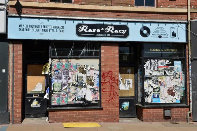 The former Rare & Racy shop - boarded up, covered in peeling fly-posters and graffitied - on May 20, 2020. Picture: Brian Eyre.