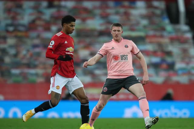 Marcus Rashford of Manchester United tussles with John Lundstram of Sheffield United: Simon Bellis/Sportimage