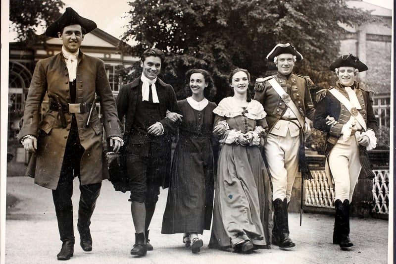 Actors in period costume stroll in the Pavilion Gardens in Buxton, between rehearsals of the play 'Devil's Disciples' for the Old Vic Festival, 27th August 1939. (Photo by Fox Photos/Hulton Archive/Getty Images)