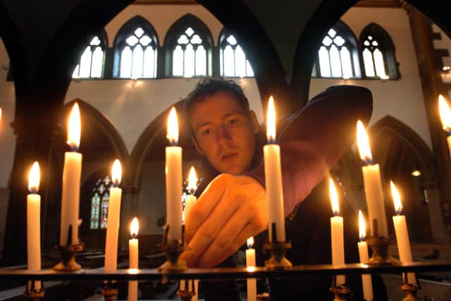 Candles being lit at Sheffield's Catholic cathedral by Michael Wood, aged 25, from Lowedges in 2005