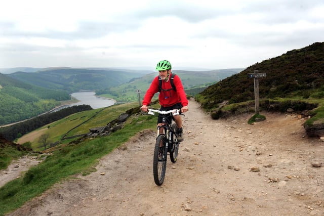 Rangers have taken to mountain bikes to patrol the Peak District National Park. Pictured is Penine Way ranger Martin Sharp at the top of Winstone Lee Tor overlooking Ladybower Reservoir in 2013
