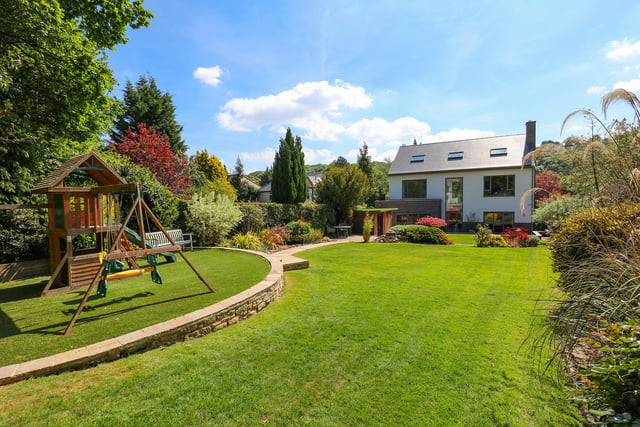 The landscaped private garden has thoughtfully-designed lawns, a play area, a patio and a timber-clad garden room.