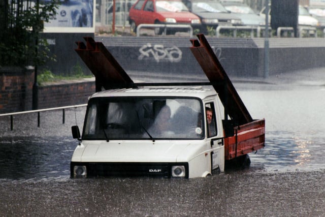 Pictured on the London Road at Heeley Bridge, where heavy rain caused flooding trapping vehicles as the water level came up... June 1993