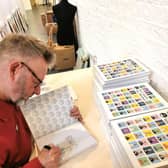 Pete McKee signs the guide to his latest exhibition Don't Adjust Your Mindset