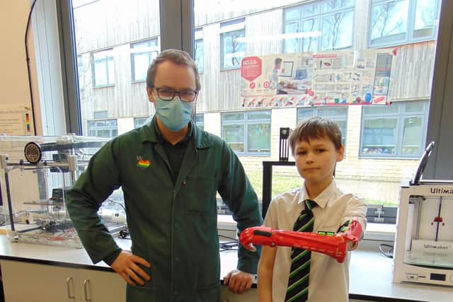 Teacher Dan Grant with Lewis and the bionic arm.