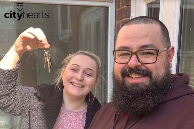 City Hearts staff Charlie Bentham and Kyle France (l-r) with the keys to the charity's new male safe house for survivors of modern-day slavery