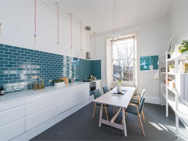 The modern kitchen has space for a dining table and chairs.