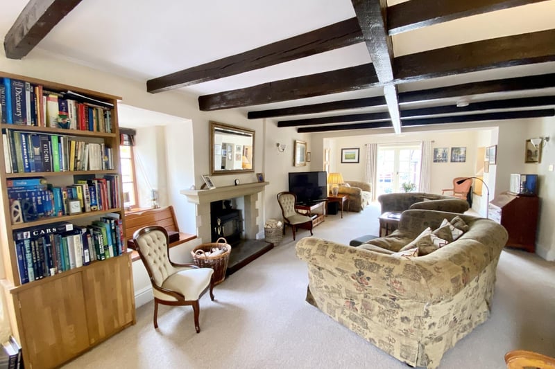 The sitting room has a window seat and a stone feature fire surround with a traditional cast-iron wood-burning stove with Yorkshire sone hearth.