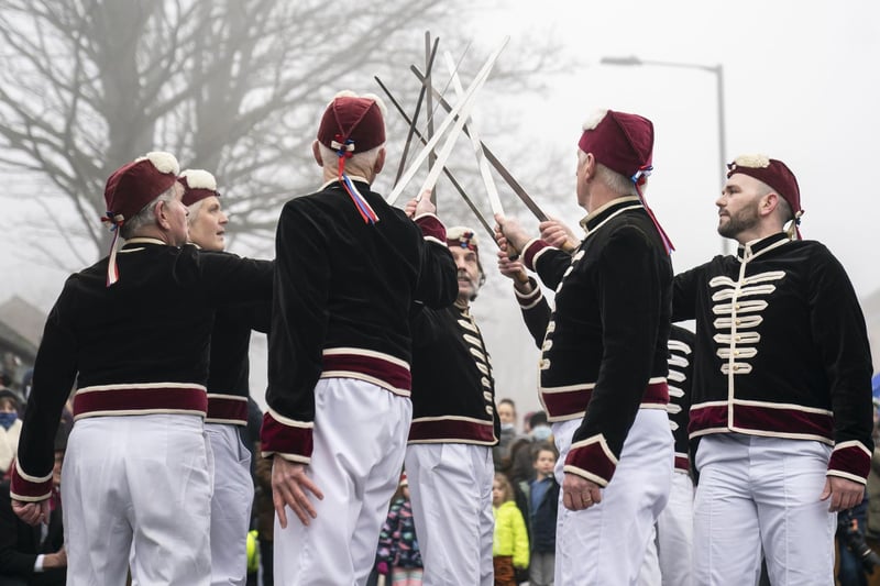 Members of the Handsworth Traditional Sword Dancers perform in Grenoside. A Longsword dance has been performed after Christmas in the village  since the early 1800's. The tradition, that now sees several sword dancing troupes perform alongside traditional morris dancers, usually takes place on Boxing Day. Picture: Danny Lawson/PA Wire