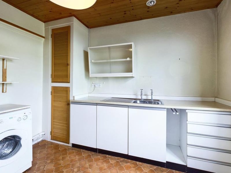 first floor kitchen - Single glazed timber framed window to the rear elevation, inset sink with pillar taps, wall mounted gas heater, cupboard housing the hot water boiler, plumbing for washing machine and power points.