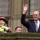 HRH Her Majesty the Queen and the Duke of Edinburgh wave to the crowds of on-lookers from Sheffield Town Hall Balcony. may 22, 2003.