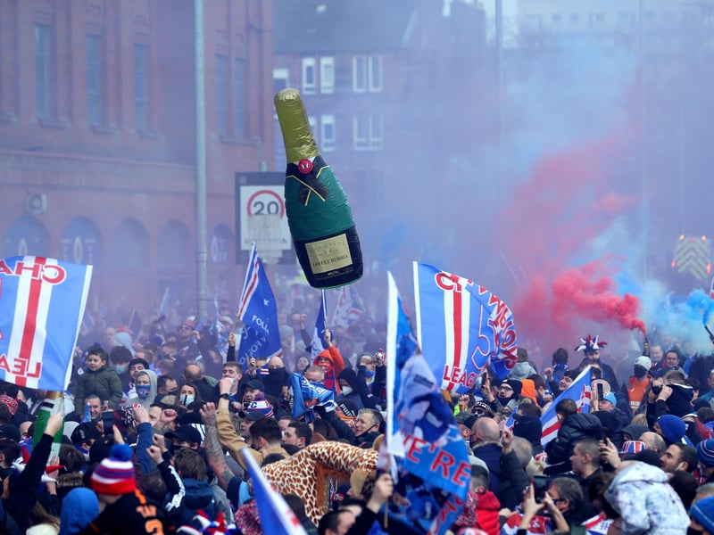 Rangers fans celebrate outside of the Ibrox Stadium after Rangers win the Scottish Premiership title.