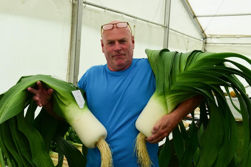 Mick Wood with his first prize-winning leeks at the show.