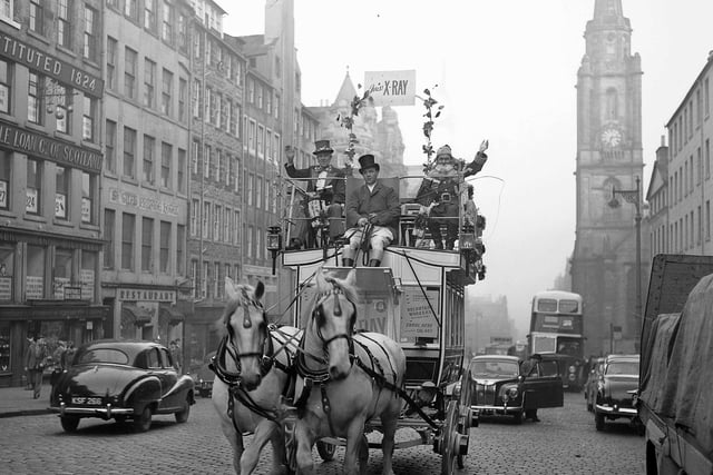 Santa Claus rides up the High Street on a horse and carriage to the City Chambers, laden with toys and gifts, in December 1957