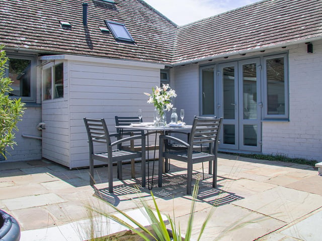 The bungalow's tidy, sun-trap back garden.
