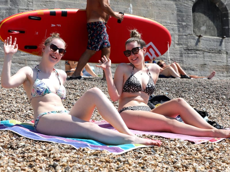 Carys Reed, 23, and Lucy Barron, 23, enjoy the sun trap at the Hot Walls.