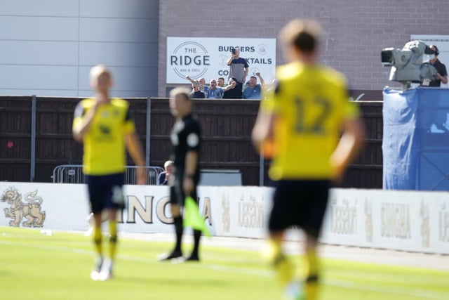 Pompey fans find a vantage point to watch at the Kassam Stadium