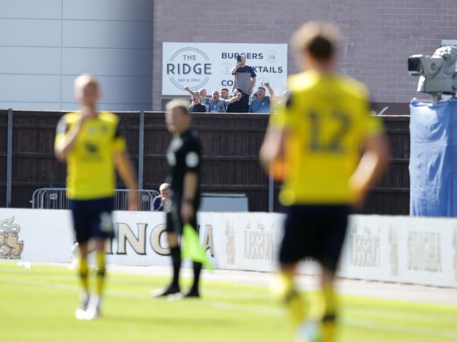 Pompey fans find a vantage point to watch at the Kassam Stadium