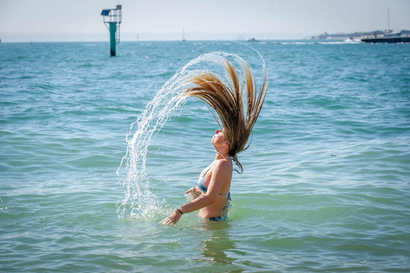 Lucy Wright having cooling her head in the sea at the Hot Walls in Old Portsmouth. Picture: Habibur Rahman