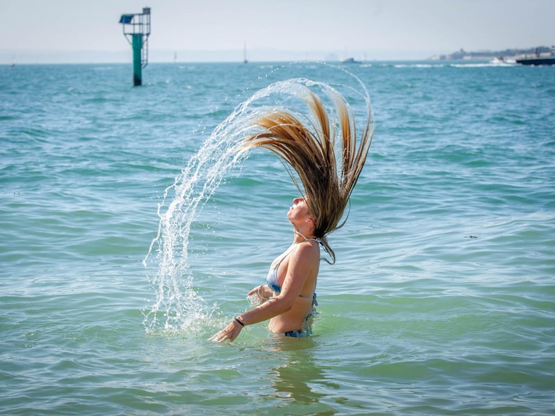 Lucy Wright having cooling her head in the sea at the Hot Walls in Old Portsmouth. Picture: Habibur Rahman