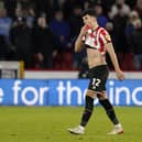 John Egan was sent-off during Sheffield United's win over Coventry City and will miss the trip to Blackpool: Andrew Yates / Sportimage