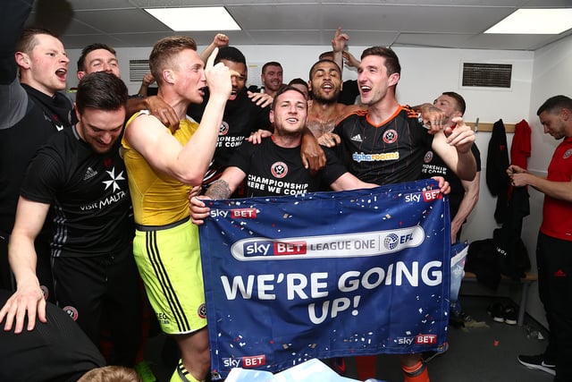 Billy Sharp, Simon Moore and Chris Basham of Sheffield United celebrate after promotion to the Championship after the Sky Bet League One match between Northampton Town and Sheffield United at Sixfields on April 8, 2017 in Northampton, England.  (Photo by Pete Norton/Getty Images)