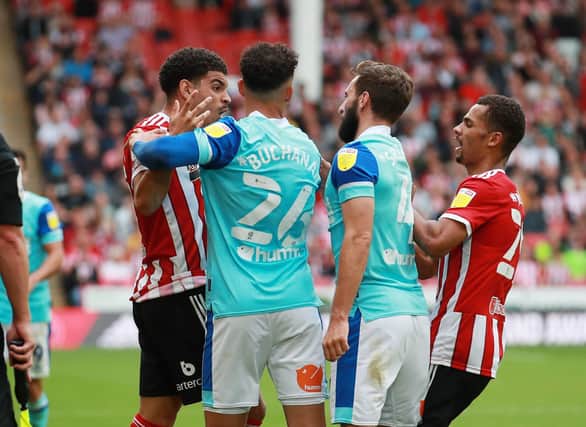 Morgan Gibbs-White of Sheffield Utd and Graeme Shinnie of Derby County have an exchange of words: Simon Bellis / Sportimage