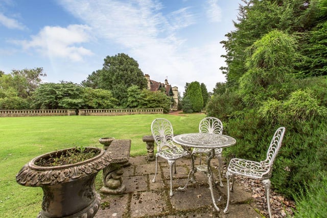 The garden comes with a partly walled croquet lawn, patio seating and a garden summerhouse.