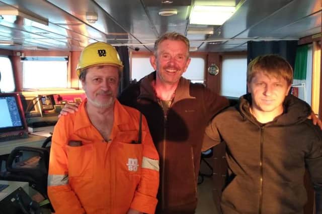 South Yorkshire writer Chris Pearsall was rescued after his yacht sank in the Mediterranean Sea. Picture shows Chris (centre) with Captain Yevgeniy Bogdanovic and chief officer Bonarenko Yuriy on the ship which rescued him
