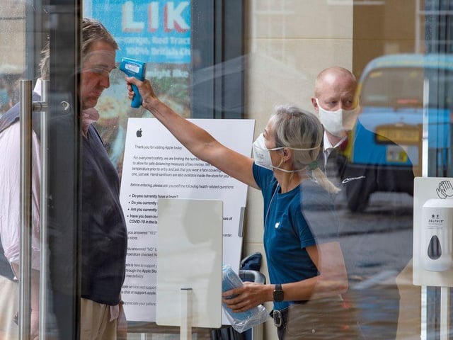 Staff carried out temperature checks before allowing customers to enter the Apple store in Edinburgh