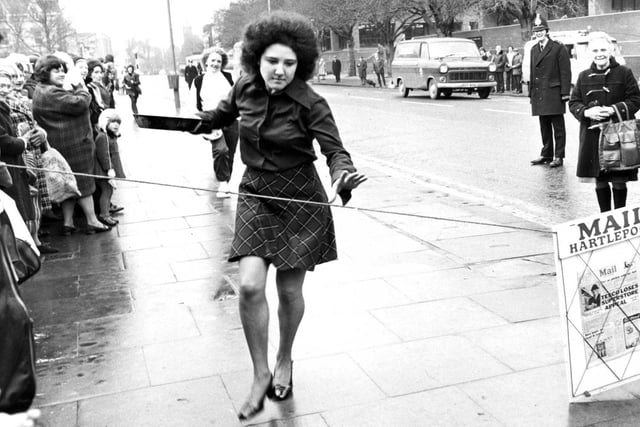 Margaret Galloway, winner of the Pancake Race in 1977, is pictured on her way to the finish line.