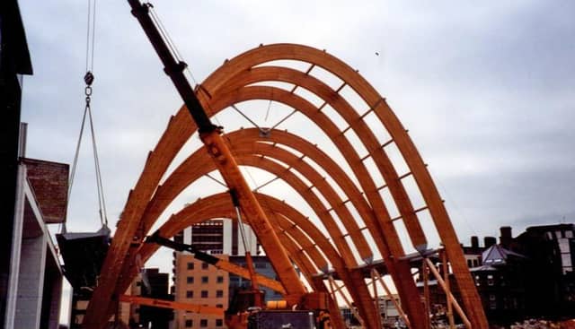 The frame is formed from 21 arches of laminated strips of untreated larch. These were intended to weather to a silvery-grey colour.