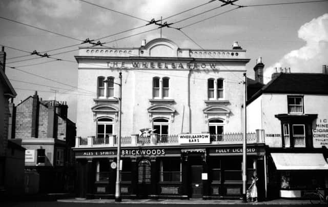 The cat's cradle of trolley bus wires outside The Wheelbarrow pub at 1 Kent Road, Southsea, Portsmouth in 1960