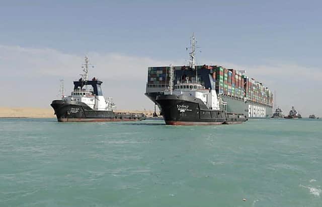 A picture released by Egypt's Suez Canal Authority on March 29, 2021, shows a tugboat pulling the Panama-flagged MV 'Ever Given' container ship after it was fully dislodged from the banks of the Suez. (Photo by - / SUEZ CANAL AUTHORITY / AFP) (Photo by -/SUEZ CANAL AUTHORITY/AFP via Getty Images)