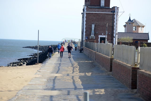 A few walkers taking their daily exercise on South Pier.