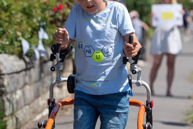 File photo dated 31/5/2020 of nine-year-old Tobias Weller whose "ginormous challenge" to use his walker to complete a marathon through the lockdown has hit the £100,000 mark (PA Photo: Joe Giddens/PA Wire).