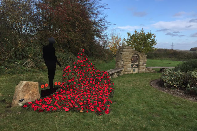 Silent soldier and hand made poppies at Kings Clipsrone Remembrance monument - Picture: David Smith