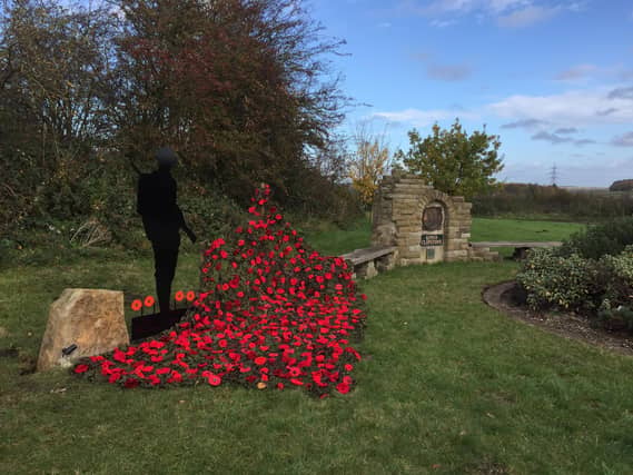 Silent soldier and hand made poppies at Kings Clipsrone Remembrance monument - Picture: David Smith