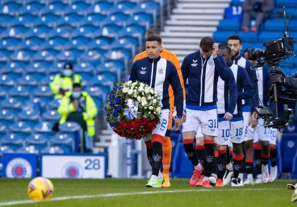 Rangers' James Tavernier carries a wreath as he leads the home team out on the 50th anniversary of the Ibrox Disaster (Photo by Alan Harvey / SNS Group)