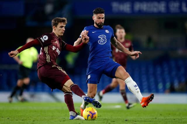 Diego Llorente of Leeds United makes a pass whilst under pressure from Olivier Giroud of Chelsea during the Premier League match between Chelsea and Leeds United at Stamford Bridge. (Photo by Matthew Childs - Pool/Getty Images)