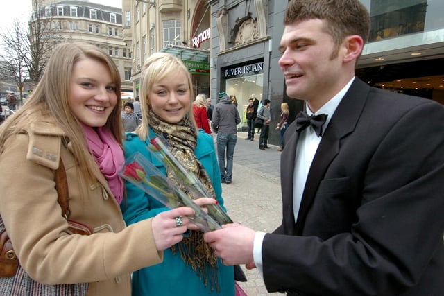 John Wagstaff offers red roses to Sheffield University students, left, Maxine Brimble and Sophie Galpin (both 20) at the Valentine's Day Funfair on Fargate in 2009