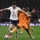 England's defender Harry Maguire (L) vies with Ivory Coast's striker Maxwel Cornet (R) during the international friendly football match between England and Ivory Coast at Wembley  (Photo by GLYN KIRK/AFP via Getty Images)