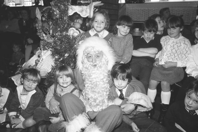 Santa's here! He paid a visit to the children at the Joplings Christmas breakfast such as this one in December 1986.