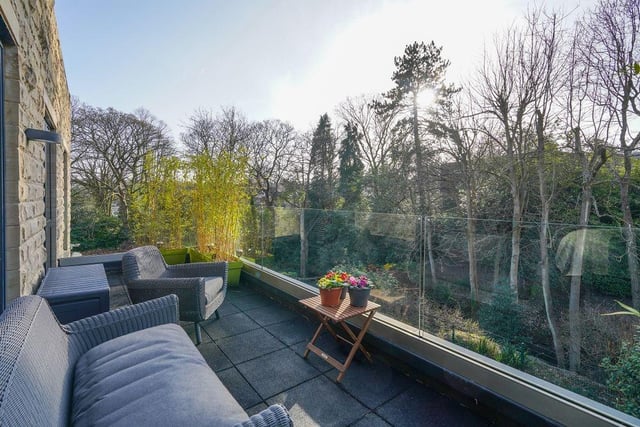 The balcony off of the master and third bedroom offers lovely views over the surrounding area.