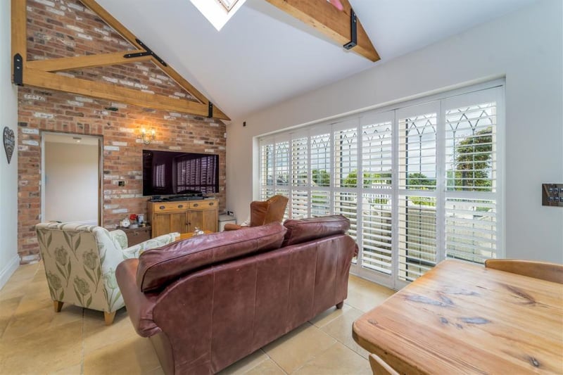 The open plan family room is the perfect place to unwind after a busy day. The dining area at the rear has  bifold doors opening onto the beautiful garden, remote controlled roof windows and blinds.