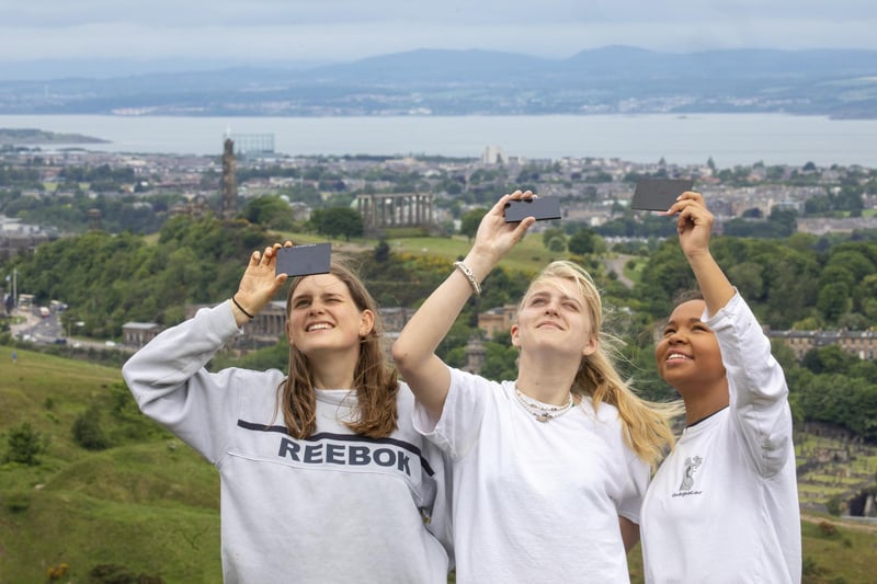 Many across the globe got their cameras out to photograph the partial solar eclipse on Thursday including Flora Gibb, Jasmine Lasnet and Chid Nyirenda at Arthur's Seat in Edinburgh.