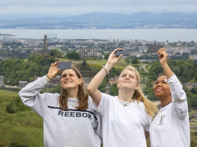 Many across the globe got their cameras out to photograph the partial solar eclipse on Thursday including Flora Gibb, Jasmine Lasnet and Chid Nyirenda at Arthur's Seat in Edinburgh.