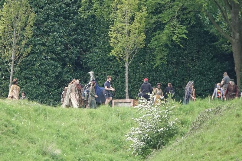 A costumed knight spotted among the actors and crew.
