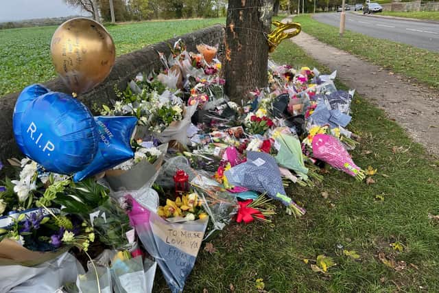 Flowers, balloons, notes and photographs have been left at the scene of the crash on Kiveton Lane.